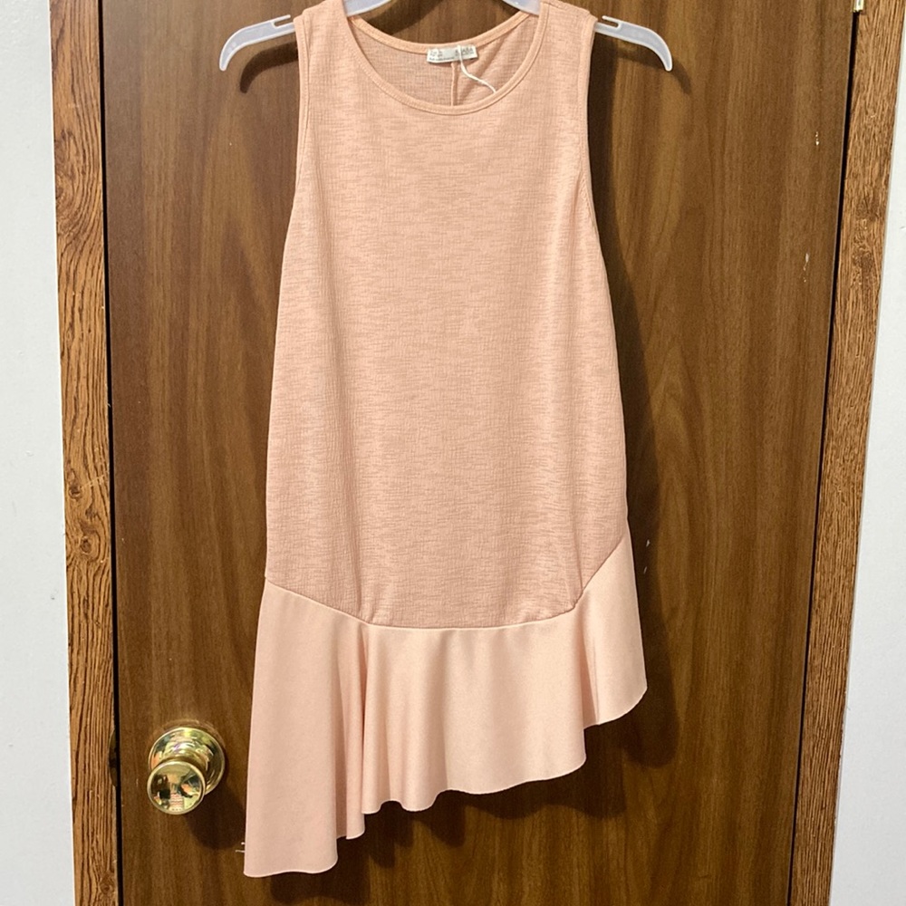 A light pink blouse with flowy fabric at the bottom size:S